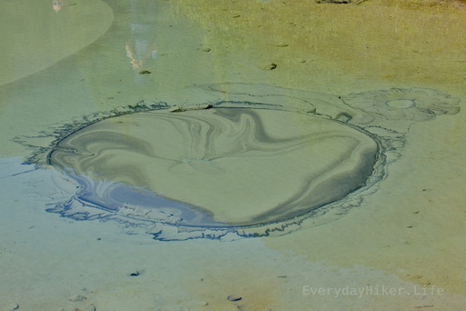 Water from the cold spring slowly fills from the sandy bottom, making designs in the pool.